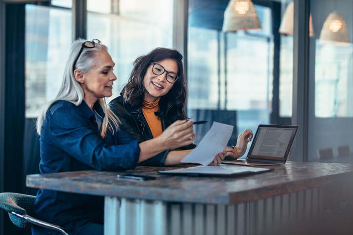 Entrepreneurs using a laptop to plan after business administration training