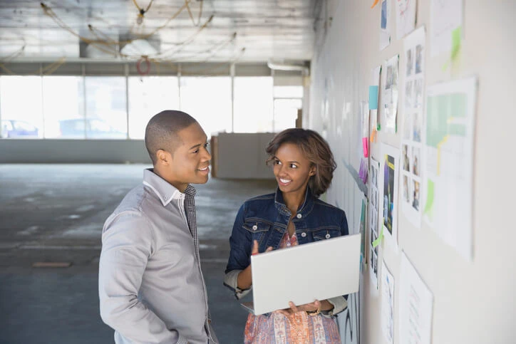 Two business developers meeting in an undeveloped office.