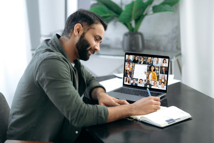 A male student is engrossed in an online learning program