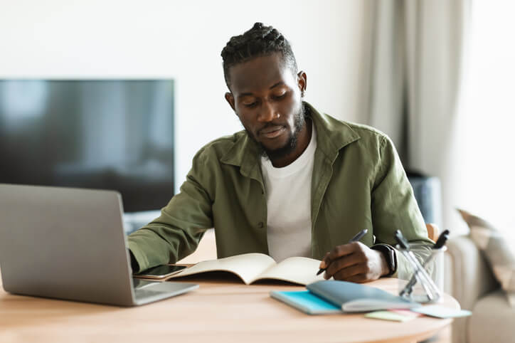 A focused male student participating in an online learning program