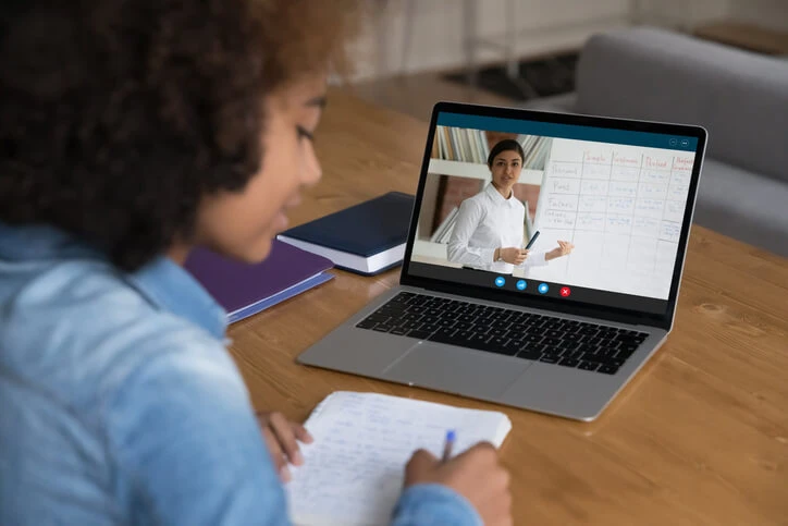 A determined young woman following an online learning program.