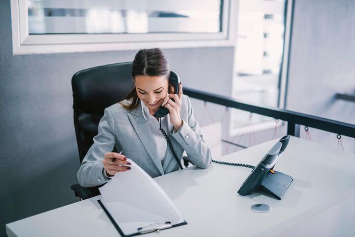 A female administrative assistant scheduling appointments after completing her administrative assistant diploma program