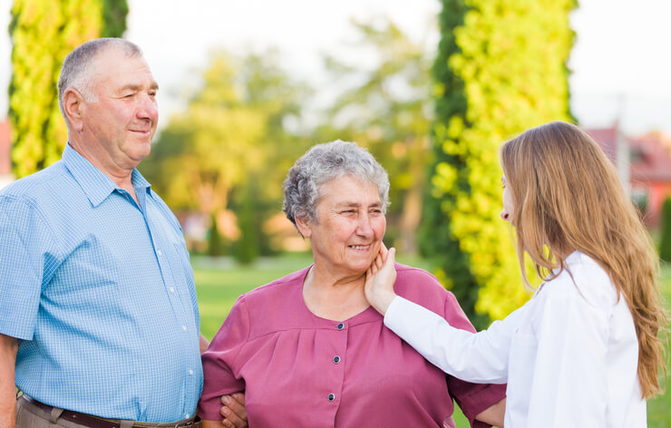 A female home support worker interacting with an elderly couple after completing home support worker training