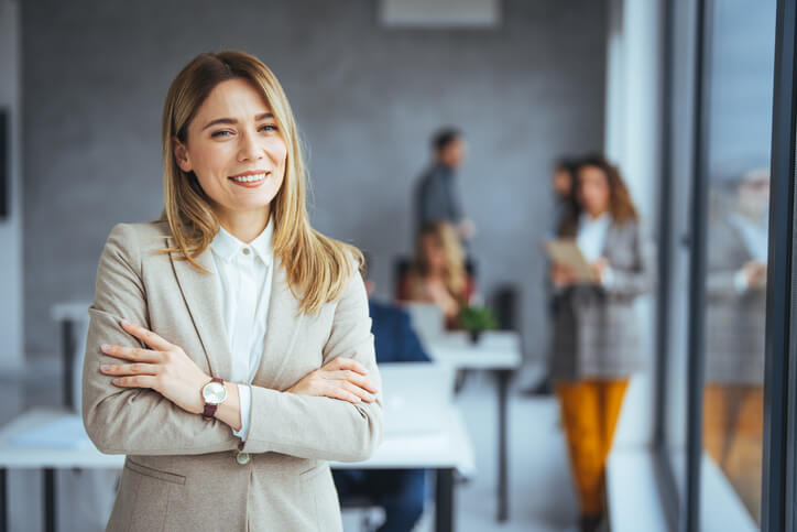 A smiling female business team supervisor in an office after completing her business administration training