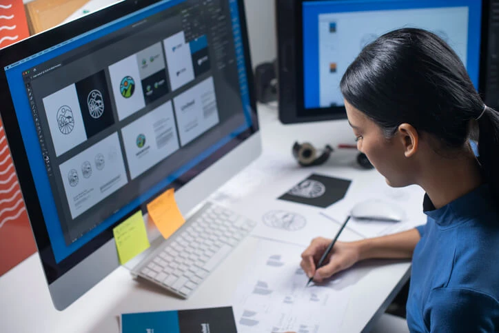 A female graphic designer developing a concept after completing her graphic design training.