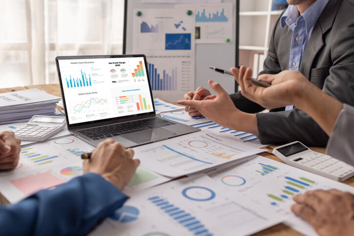 A team of business administration training graduates in a strategy meeting in an office