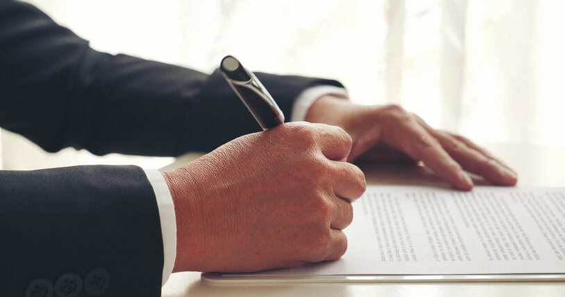 A focused male legal assistant researching a case after completing his legal assistant training