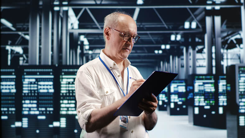 A focused network administrator optimizing a company’s data center after completing his network administrator training