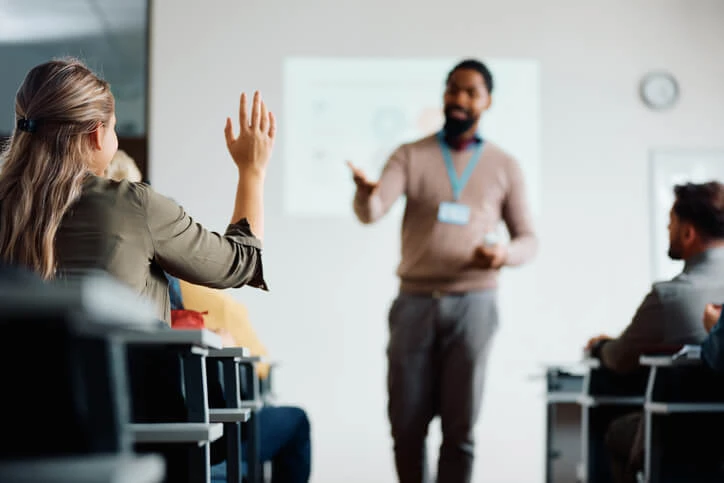 A college instructor answering student questions.