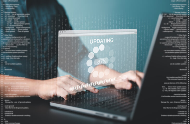 A male network administrator updating a firm’s security software after network administrator training