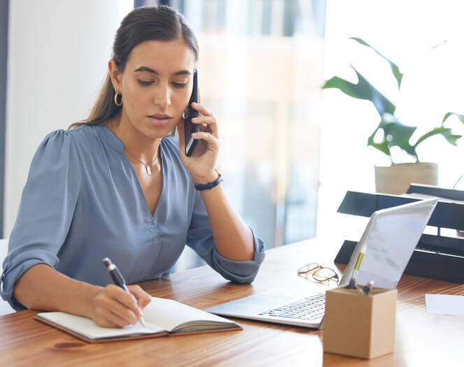 A focused female sales assistant handling financial records at work after completing her administrative assistant training