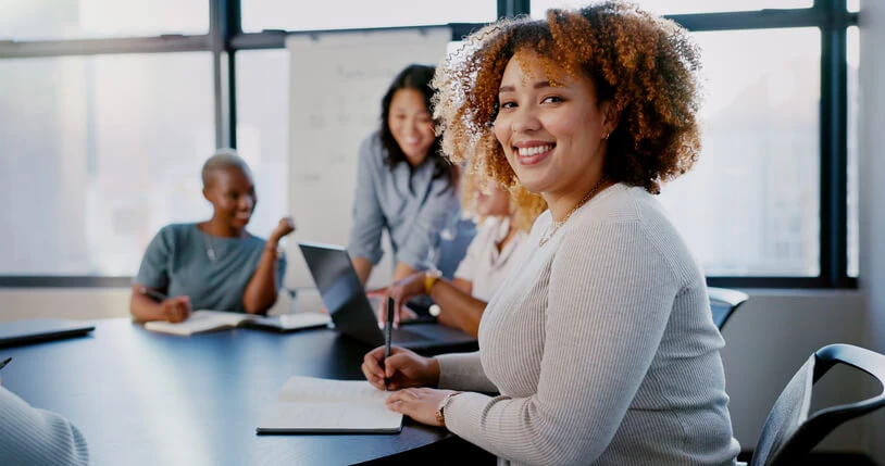 A smiling female professional undergoing business administration training at work.
