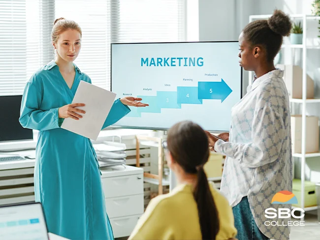 A marketing coordinator giving a presentation to her team at work.