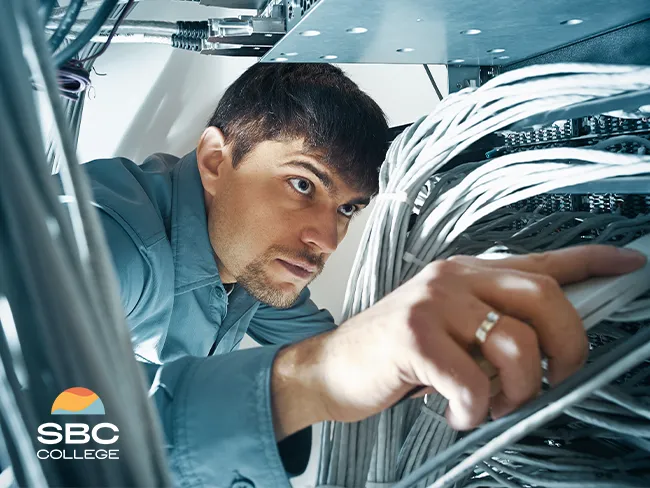 A network administrator repairing a computer in an office workspace, ensuring proper system performance and connectivity.