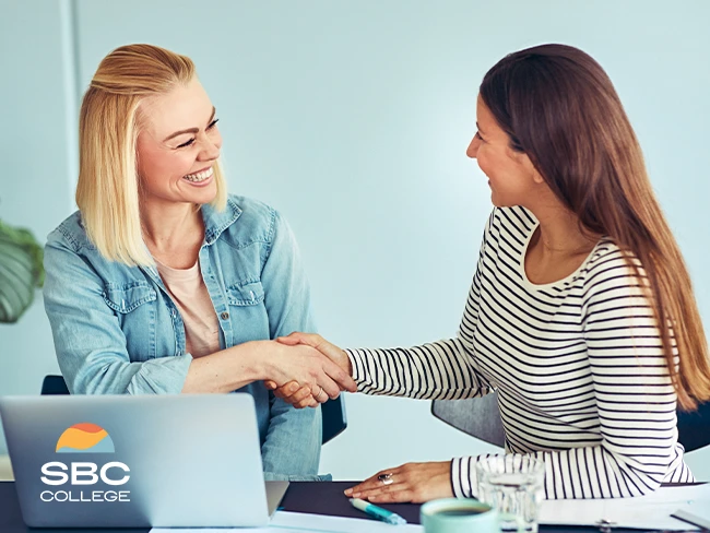 Two adults discussing about career growth and professional development at a networking event.