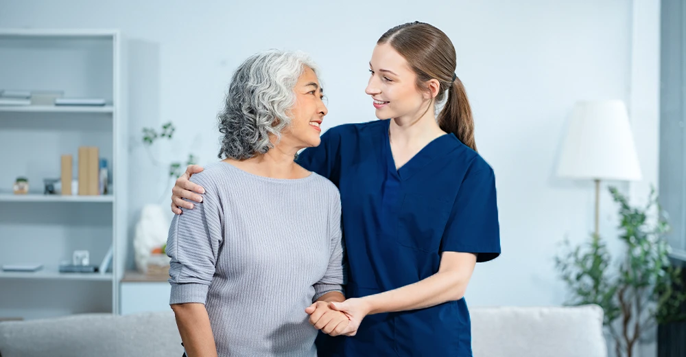 A health care aide providing elderly care assistance at a private residence.