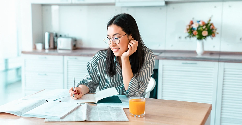 A college student learning from the comforts of her home using proven study strategies for success.
