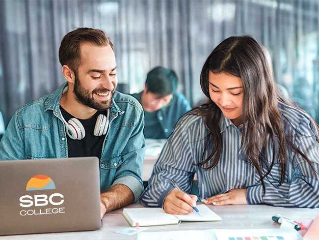 Two college students studying together on campus using active learning techniques.