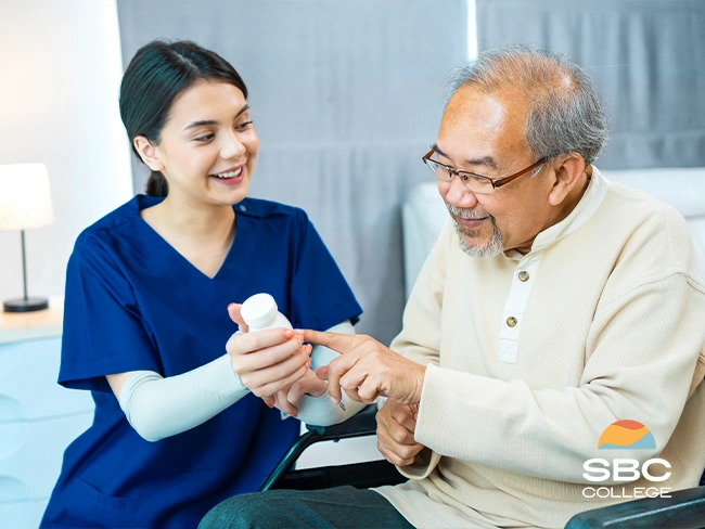 Personal care aide supporting elderly client with medication as part of daily health routine.