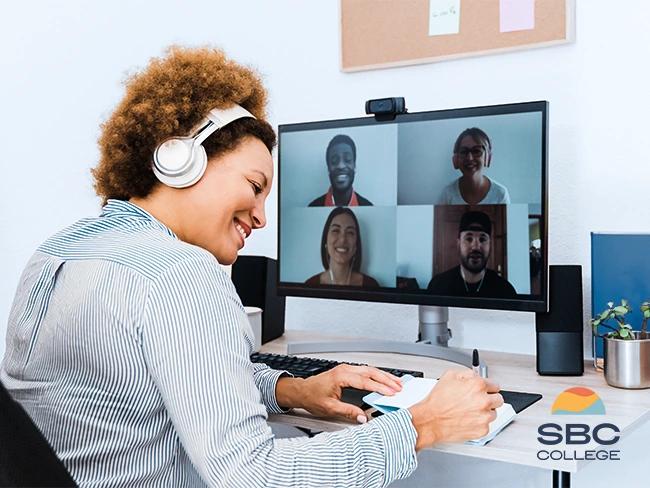 A college student engaging in virtual networking with classmates from the comfort of her home.