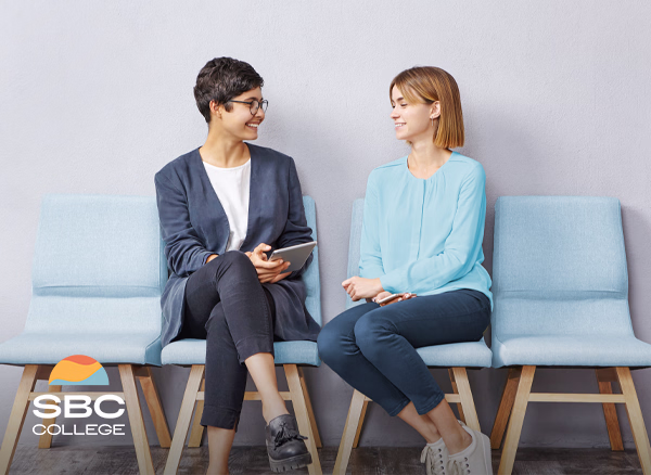 Two job applicants discussing the questions they can be asked while waiting for their interview.