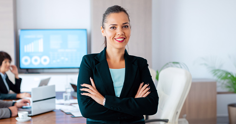 An account manager leading a meeting with her team in a boardroom.