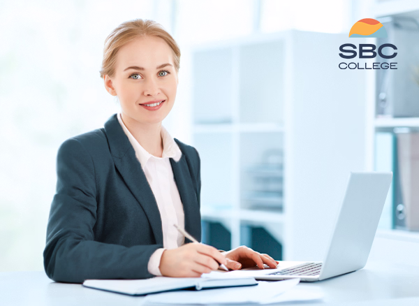 Female Business Administration Management graduate applying her training in a workplace setting.