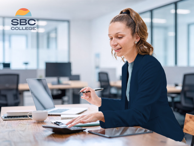 An accounting and payroll administrator calculates employee wages.